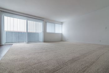an empty bedroom with white walls and a large window at Park Apartments, Norwalk, 90650